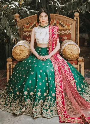 Emerald green lehenga choli front view with white floral blouse and bright pink embroidered dupatta