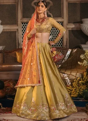 Mustard mehndi lehenga choli front view with coral dupatta and ornate gold floral hem embroidery