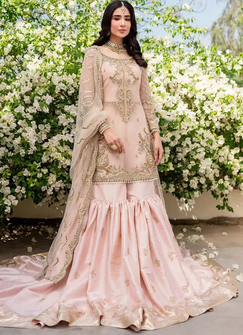 Peach Nikkah Farshi Gharara with Pearl-Drop Shirt Hem Peach farshi gharara front view with gold embroidered short shirt, sheer dupatta and sweeping floral hem border
