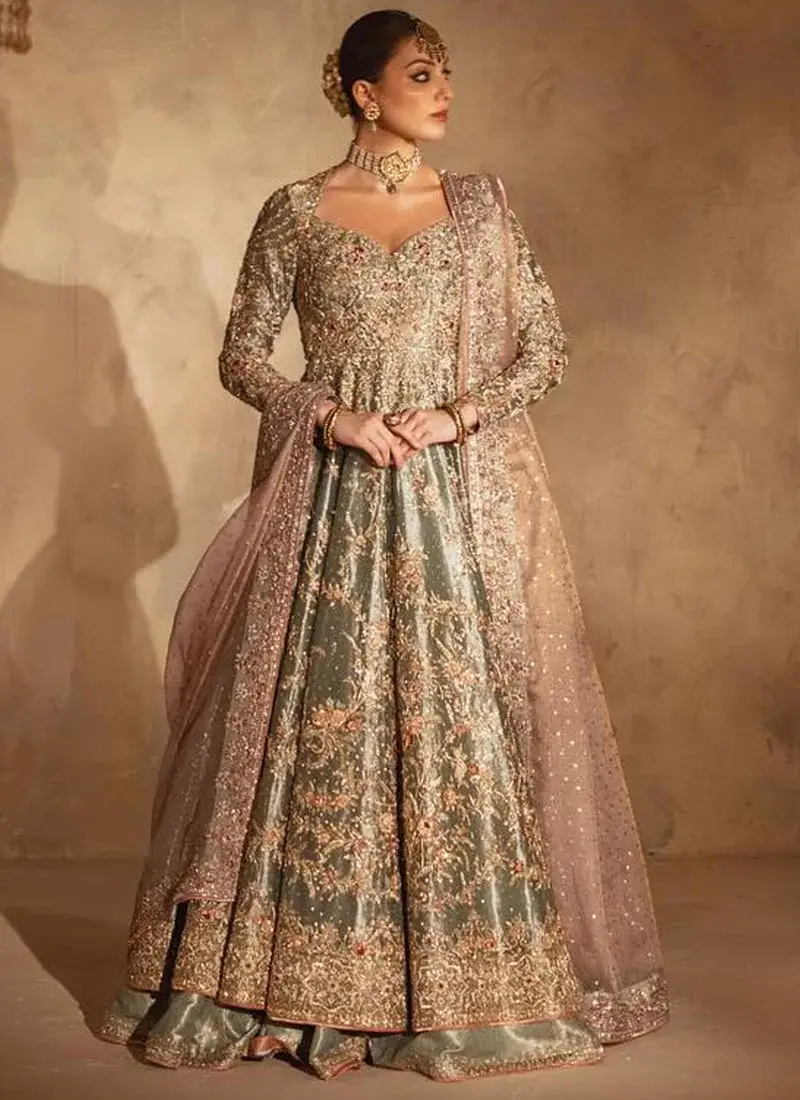 Sage Green Walima Long Peshwas with Lehenga with Tasselled Keyhole Back Sage green walima peshwas with jamawar lehenga in angled full-length view and dusty pink dupatta